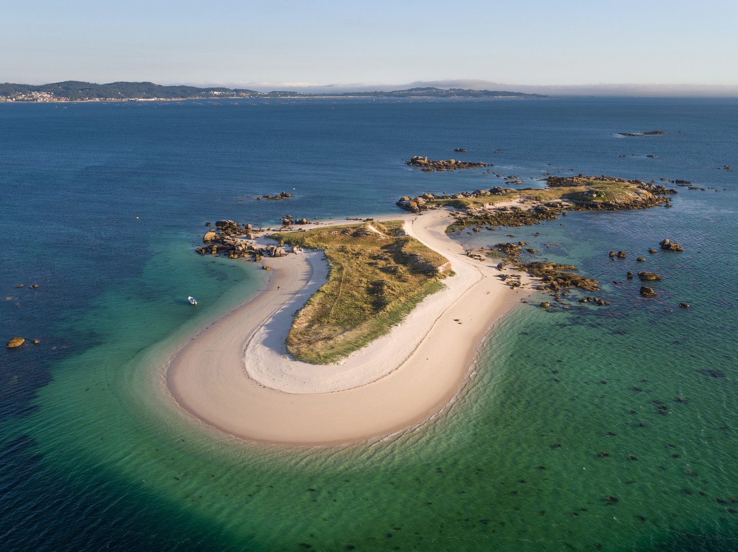 Aerial view of Areoso Island with white-sand beaches and turquoise water, the kayak tour destination in the Ría de Arousa